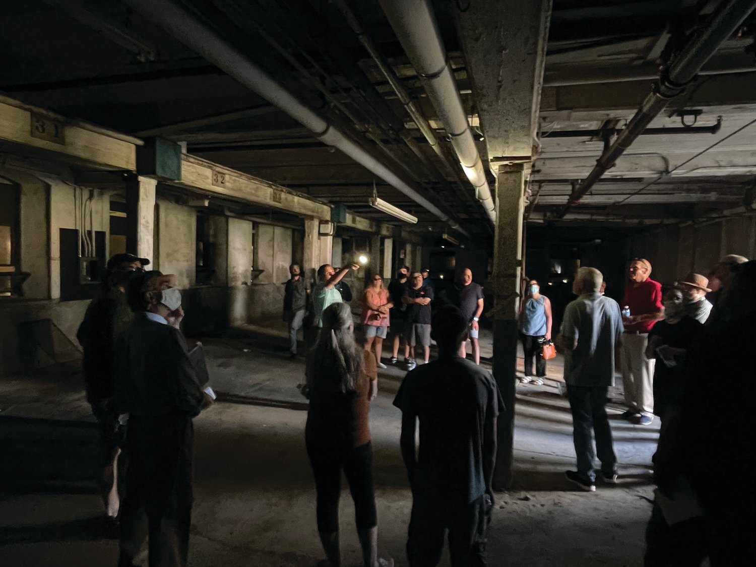 IN THE DARK: Chris Reynolds of Brady Sullivan Properties discusses his company’s approach to mill renovations during one of the inside stops on Saturday’s site walk. The company, which began in the early 1990s in New Hampshire, has expanded to include developments in Massachusetts, Vermont and Rhode Island.